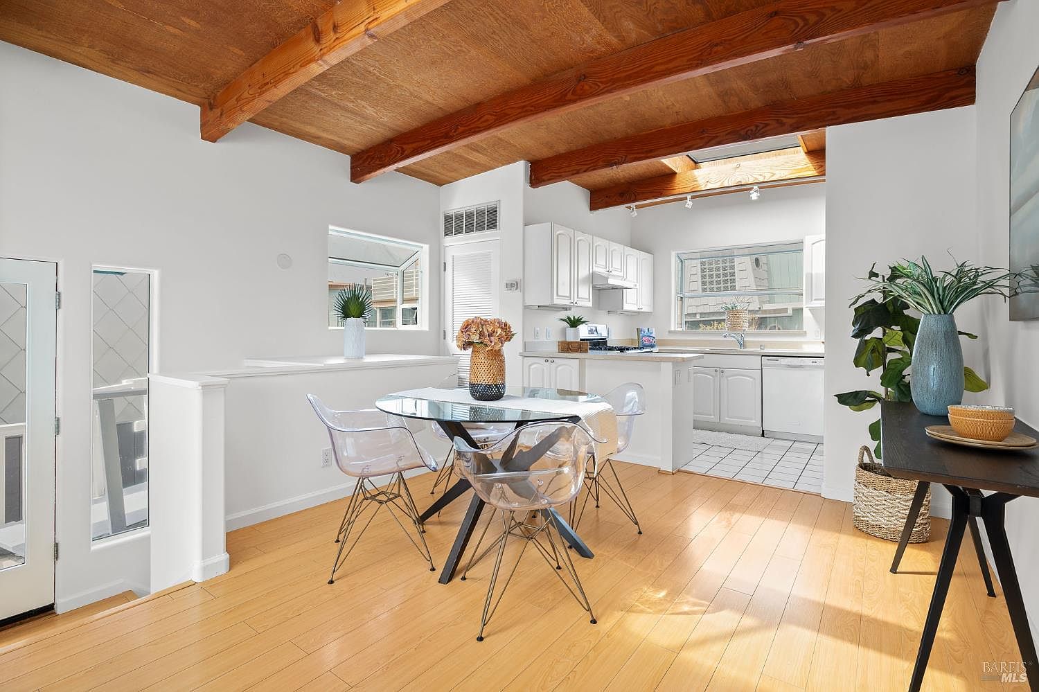Designer kitchen with custom cabinetry, integrated appliances, and a long island opening to the dining and living spaces.